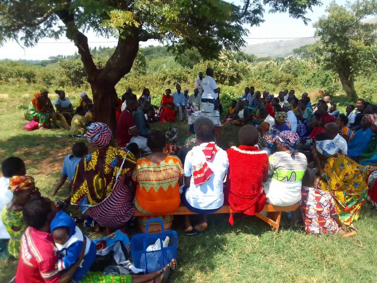 Community members smiling together outdoors in Ghana, demonstrating the positive impact of collective action